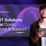 Top IT Solutions Dubai: Costs, Services & Support A purple-themed promotional banner with a futuristic, wavy grid pattern in the background. A young, smiling man with glasses is on the right side of the image, holding a tablet and looking directly at the camera. He is wearing a dark, corduroy-like jacket over a white t-shirt. On the left side, a large, translucent, rounded rectangle contains the text "Top IT Solutions Dubai: Costs, Services & Support". The words "IT Solutions" are highlighted in bold. At the top left of the rectangle, the logo for "ZAB-Tech" is visible along with the website address "zabtechdigital.ae". The design is modern, professional, and tech-oriented.